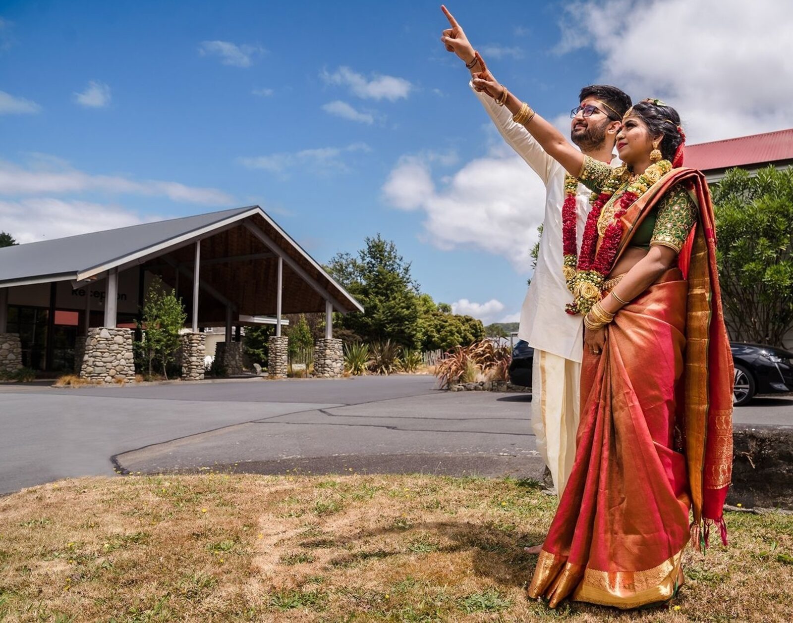 Bride and groom in traditional South Indian attire on an outdoor wedding day