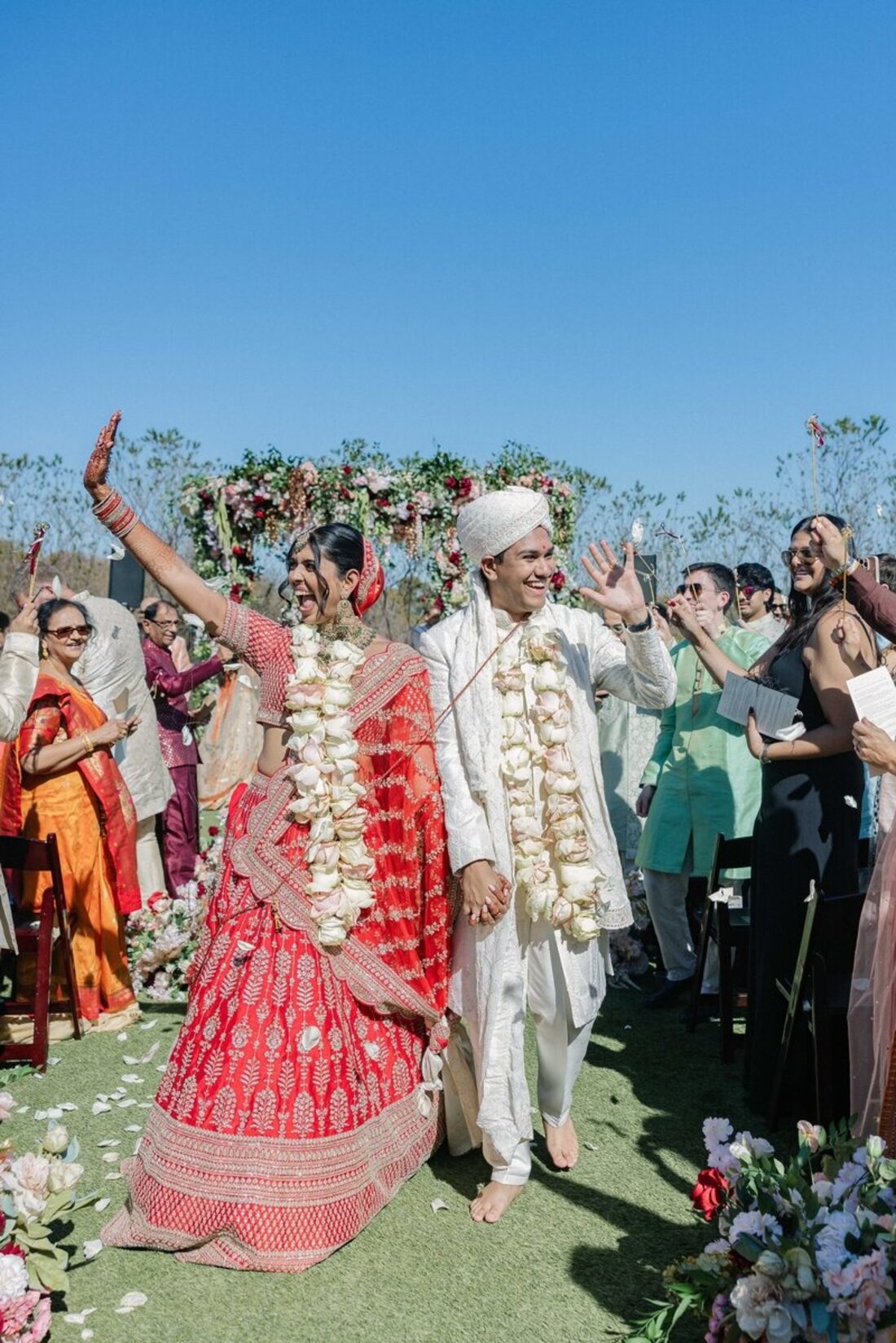Bride and groom joyfully walking down the aisle after their ceremony