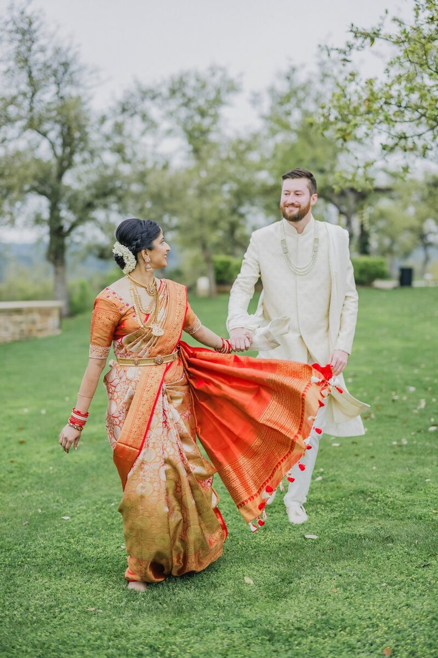 Couple at historic stone arch, blush lehenga