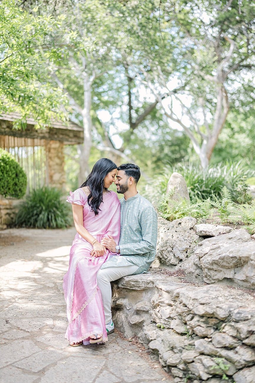 Couple in pink and sage on garden bench