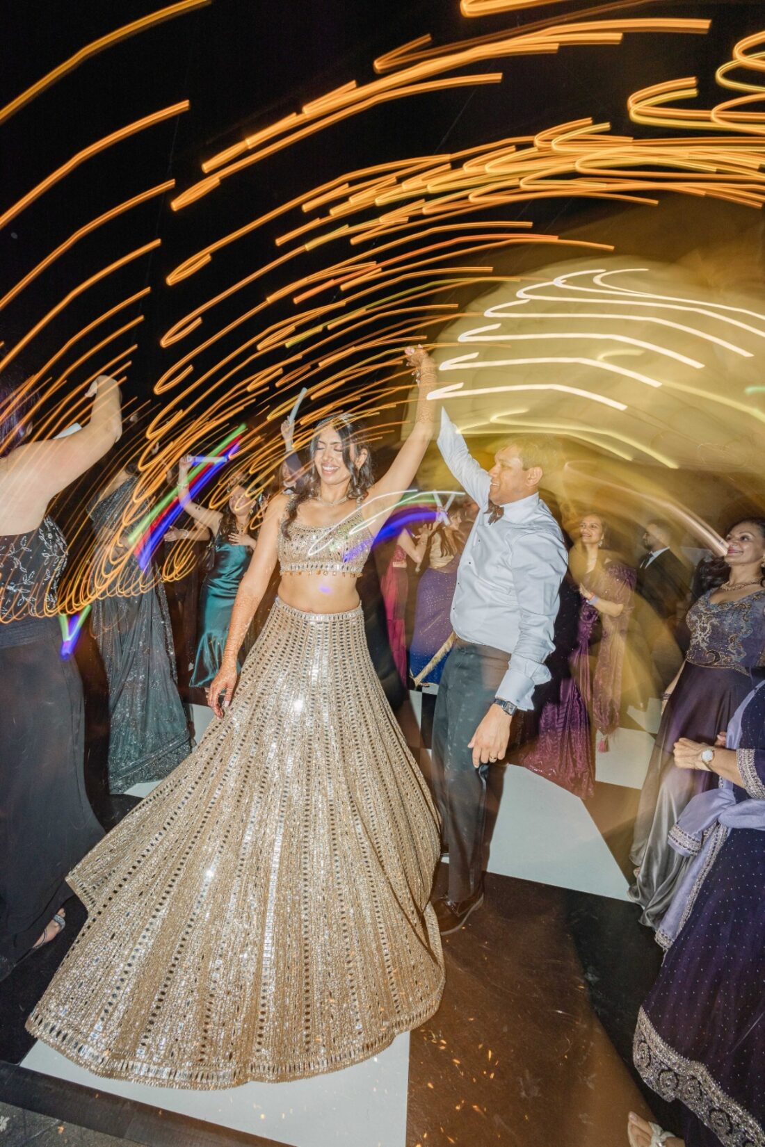 Bride dancing under swirling reception lights